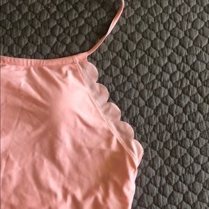 Never-worn, pale pink one-piece swim suit.